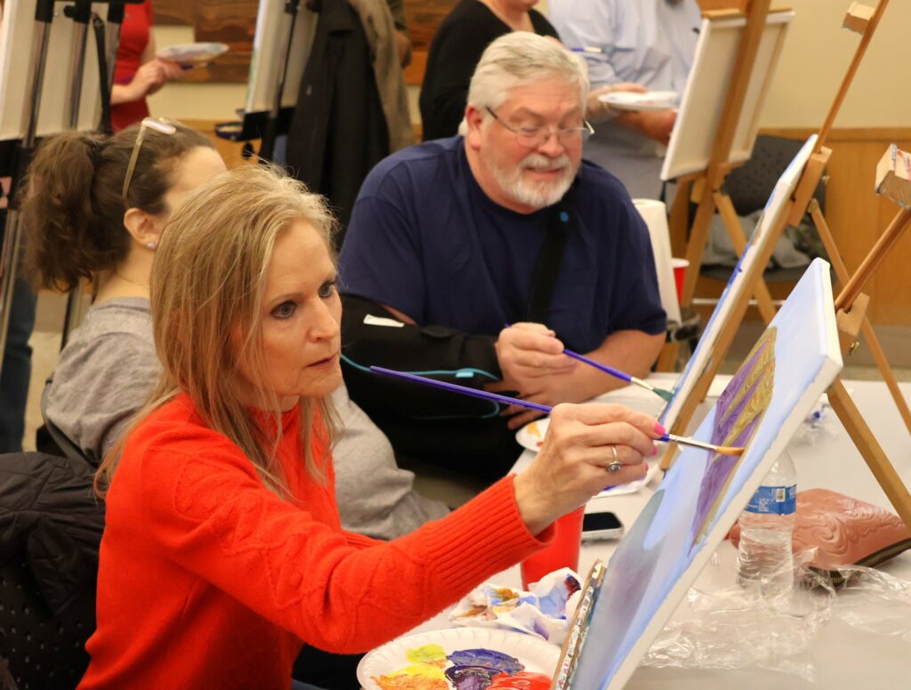 Attendees paint.
