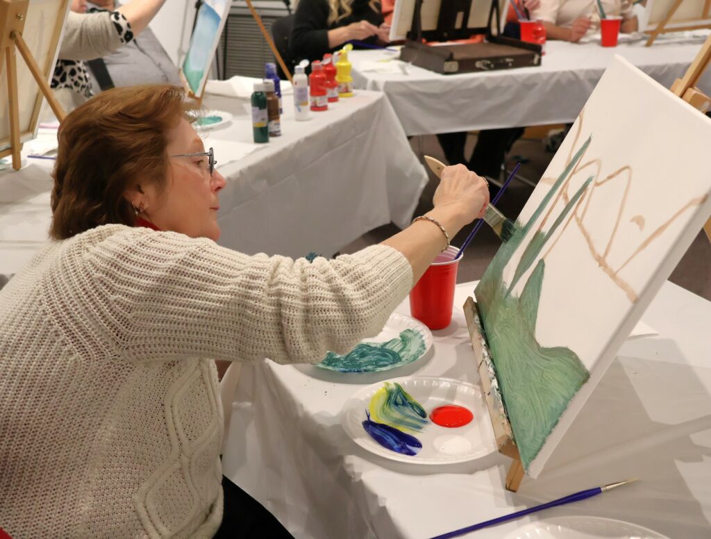 Attendees paint.