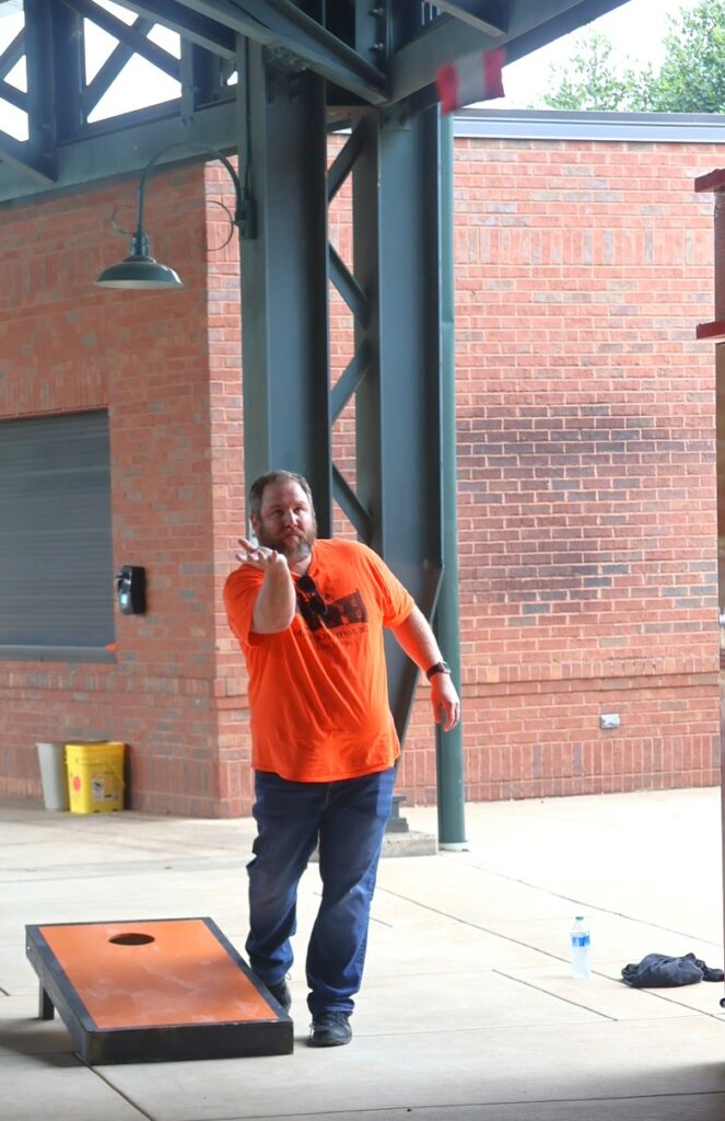 Greg Fay tosses a cornhole bag.
