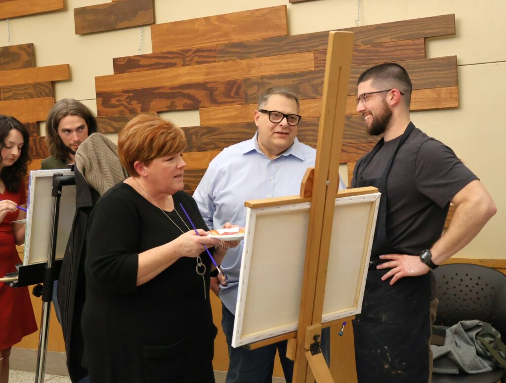 Benjamin Conley, right, speaks with Edward and Elizabeth Roberts.