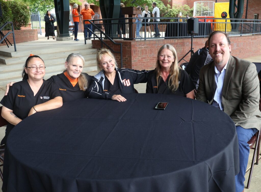 Dr. David Cook, right, sits with members of the Facilities Management Department.