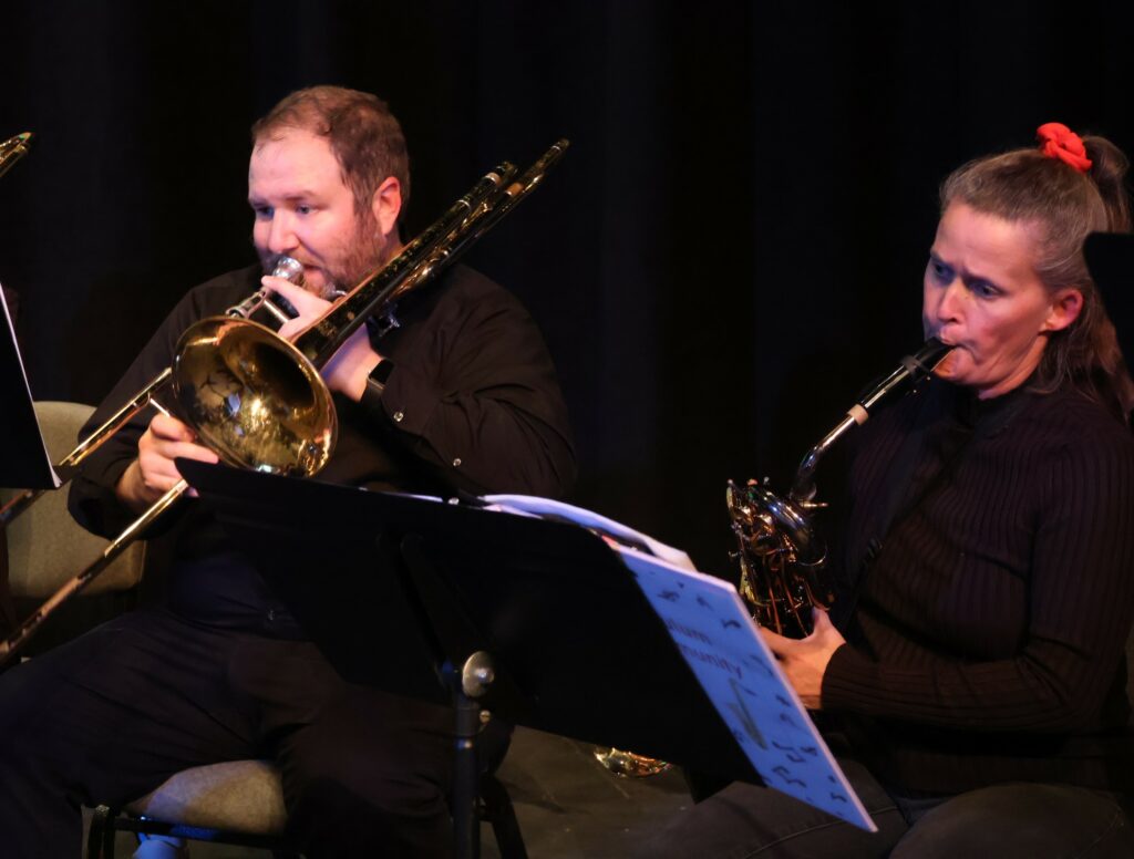 Two band members perform prior to the concert's start.