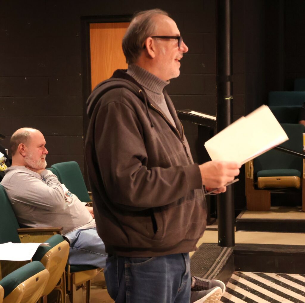Ed Breese, one of the directors, gives instructions to actors who are auditioning.