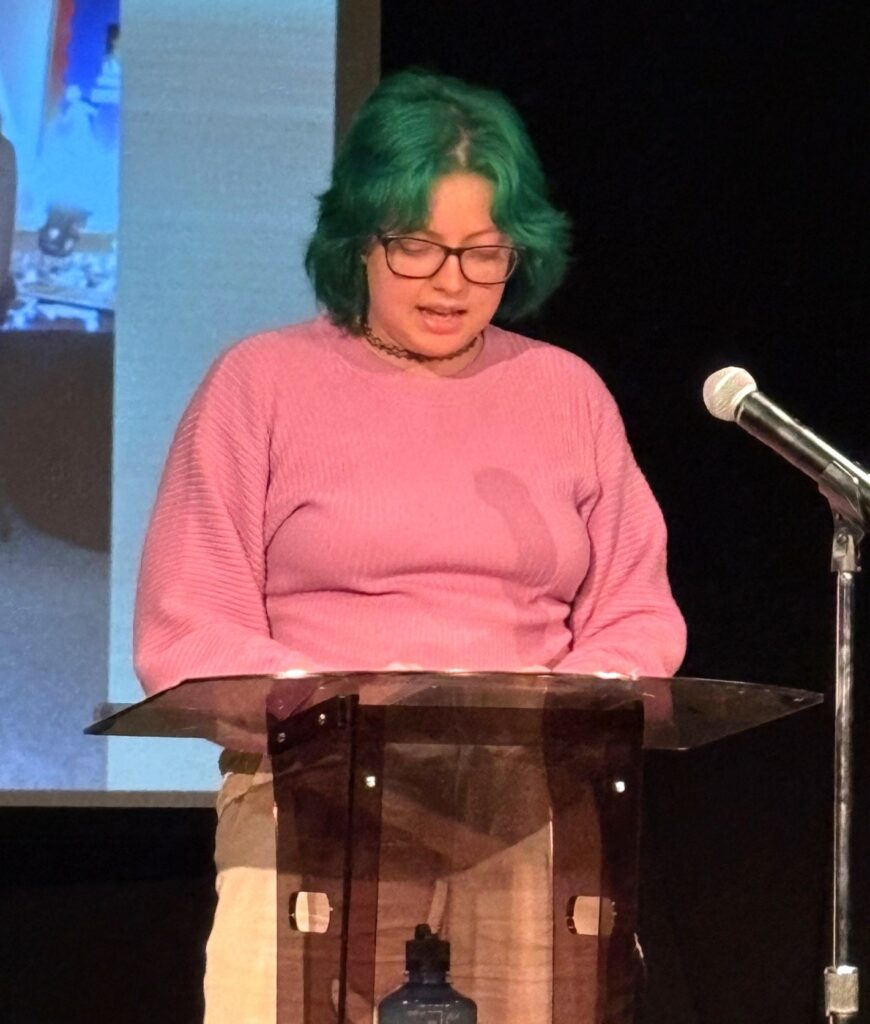 Student Kiersten Paxton reads a poem.