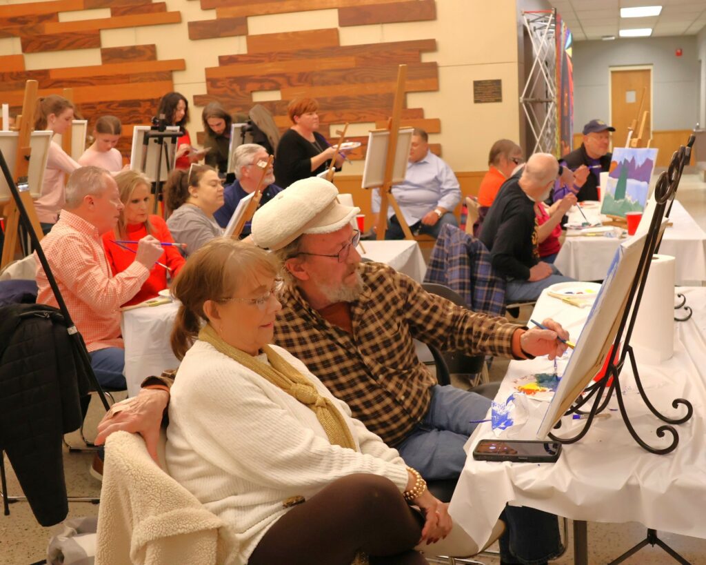 Attendees paint.