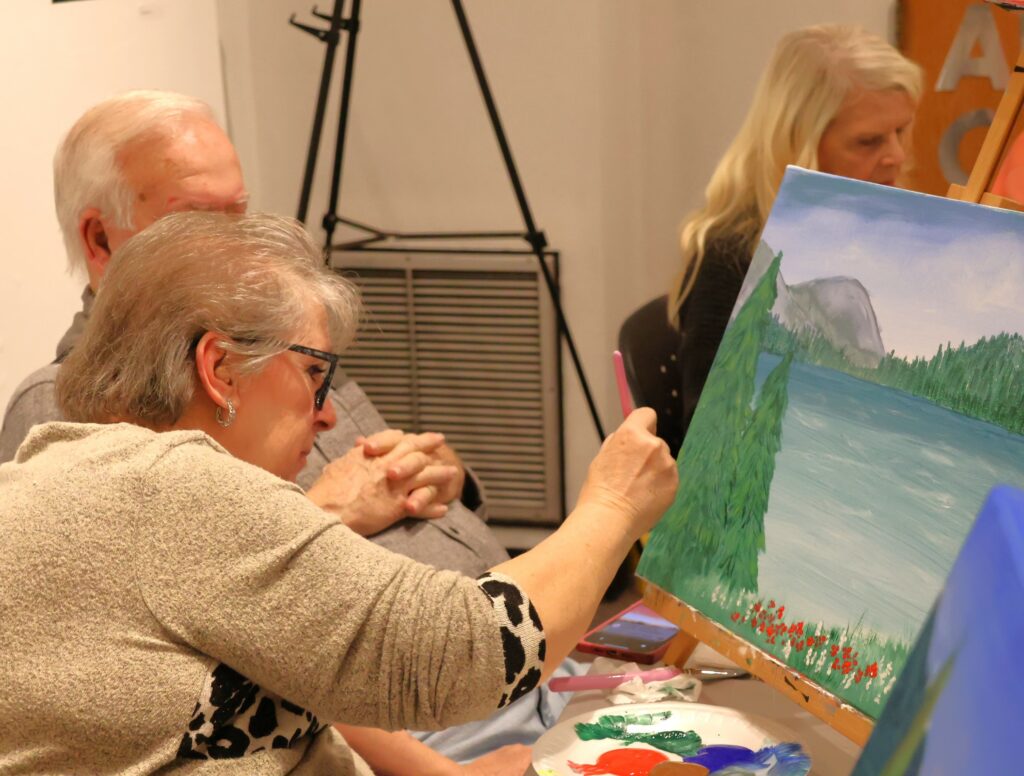 Attendees paint.