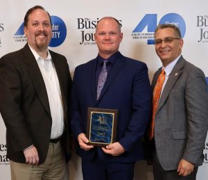 The Rev. E.J. Swatsell, middle, stands Dr. Scott Hummel, right, and his supervisor, Dr. David Cook.