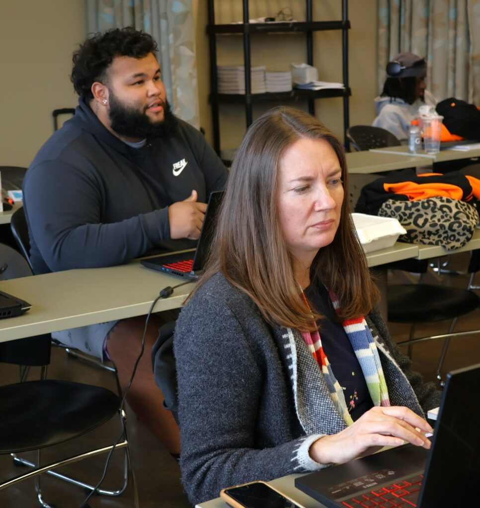 Student Xavier Velazquez, left, and a community volunteer participate in VITA training.
