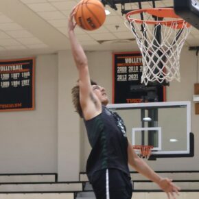 A player goes for a dunk during warmup.