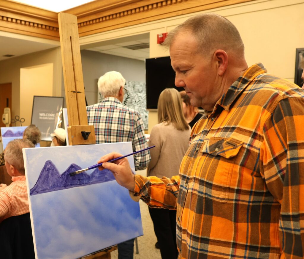 Matthew Nasekos, executive director of Longview ranch, paints.
