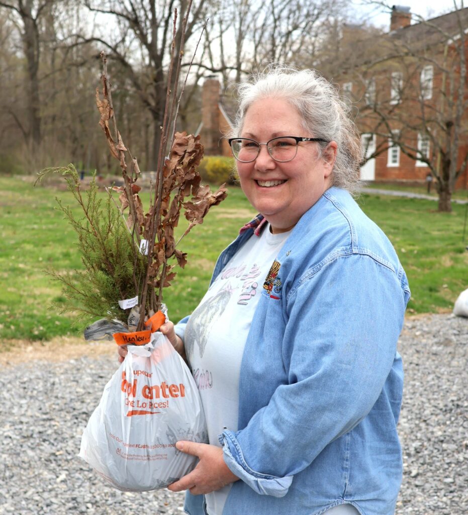 A woman holds her seedlings.
