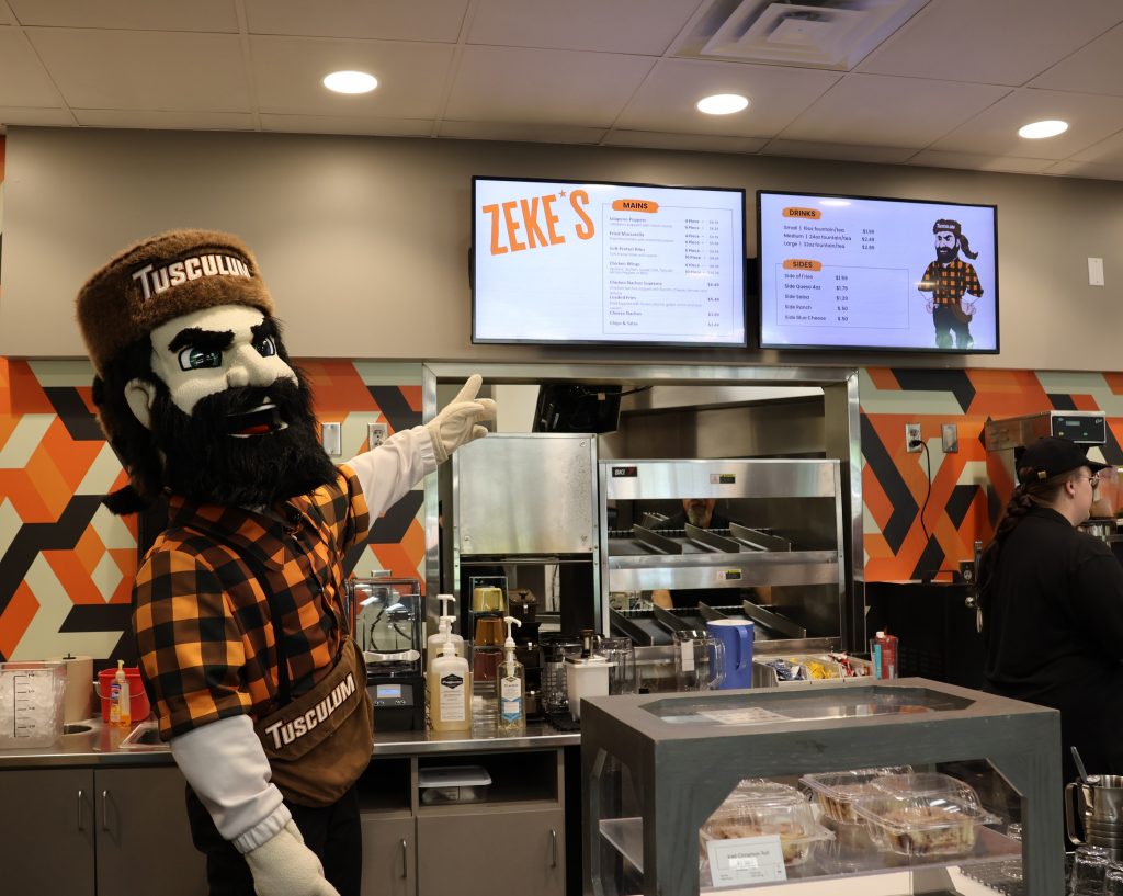 Zeke points to the menu.
