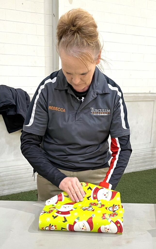 Rebecca Wood wraps a gift.