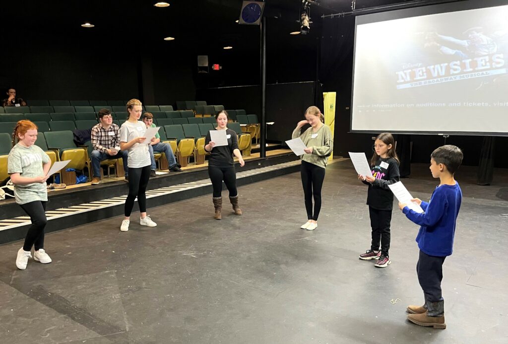 Potential cast members audition for "Newsies."