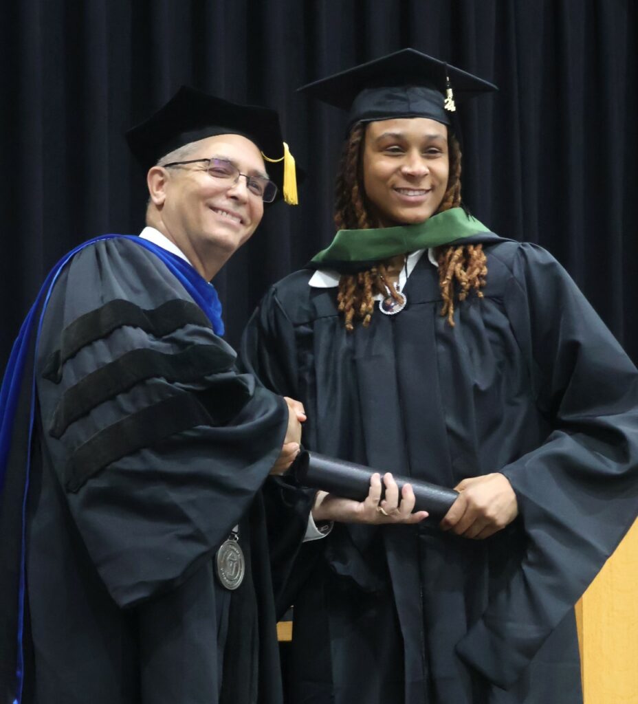 Dr. Hummel, left, congratulates a graduate.