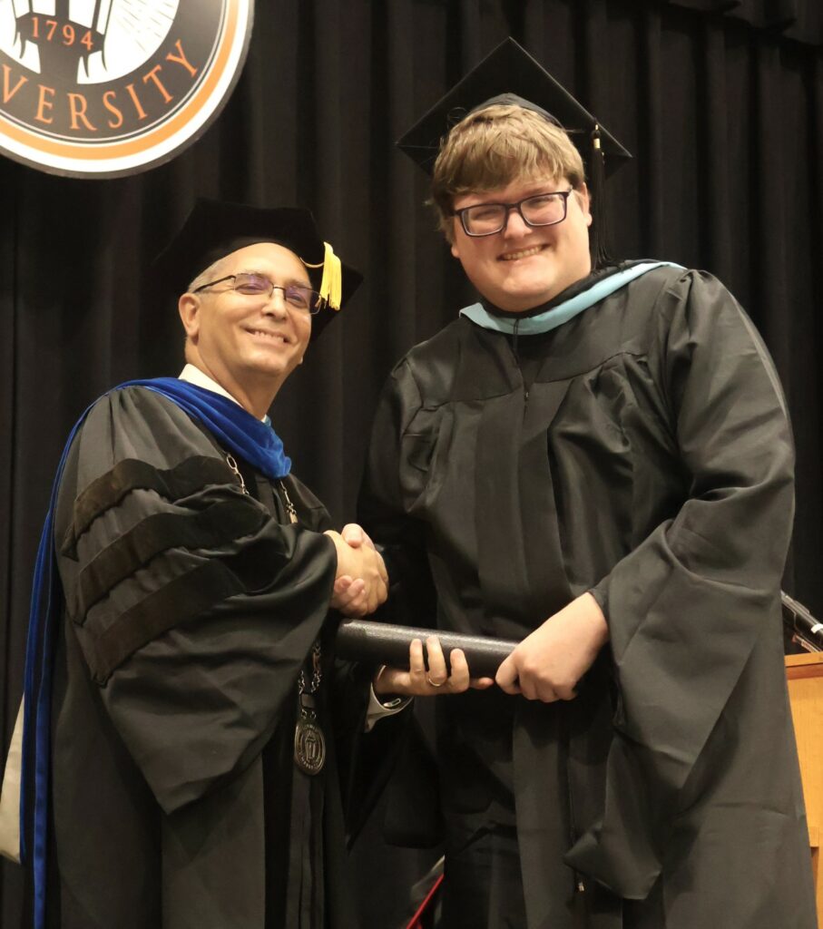 Dr. Hummel, left, congratulates a graduate.