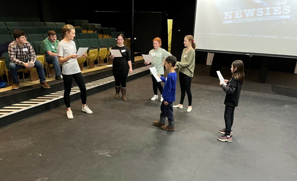 Potential cast members audition for "Newsies."