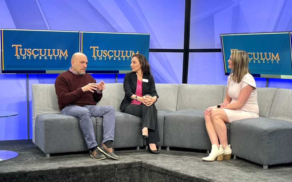 Bill Bledsoe, left, speaks about the Valentine's Painting Night, while Rouja Green, center, and Kelly Grosfield, the interviewer, listen.