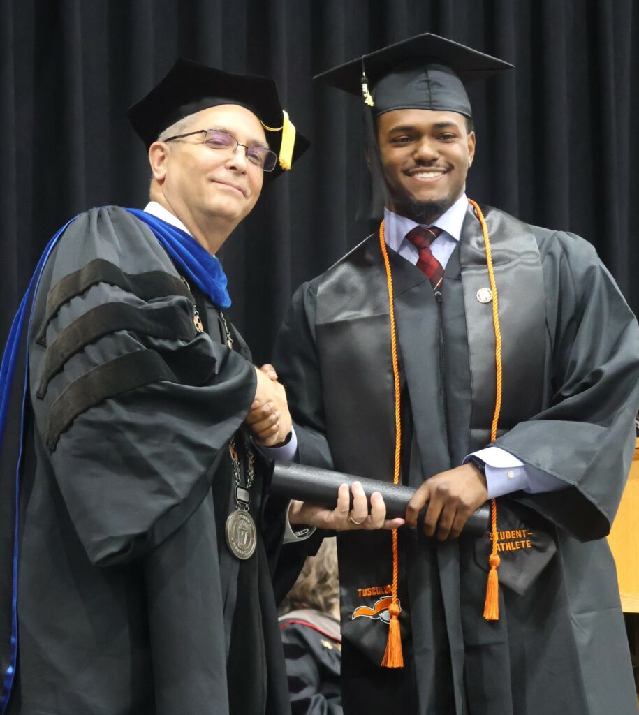 Dr. Hummel, left, congratulates a graduate.