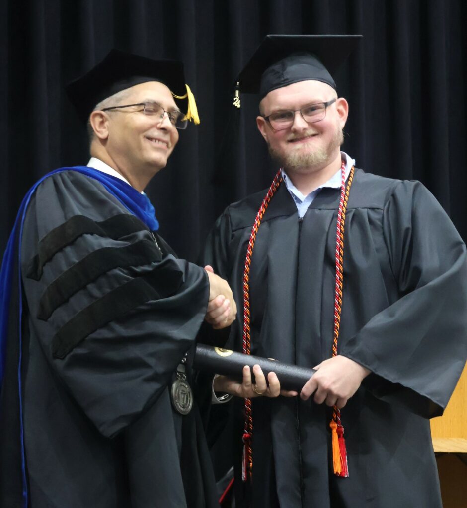 Dr. Hummel, left, congratulates Parker Bales.