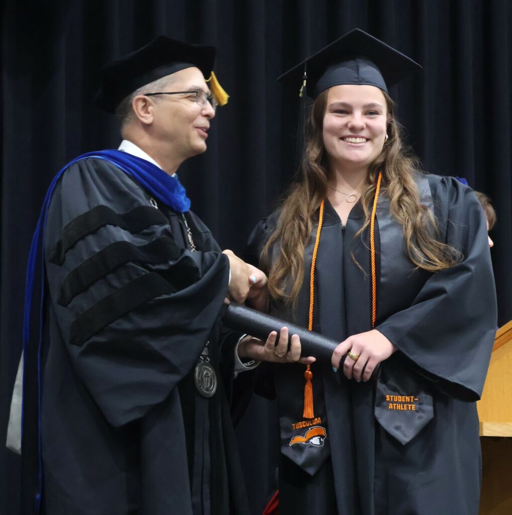Dr. Hummel, left, congratulates Lucy Brewer.