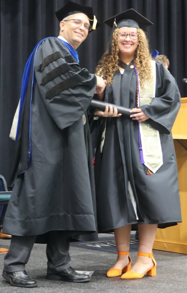Dr. Hummel congratulates Isabelle Delbridge.