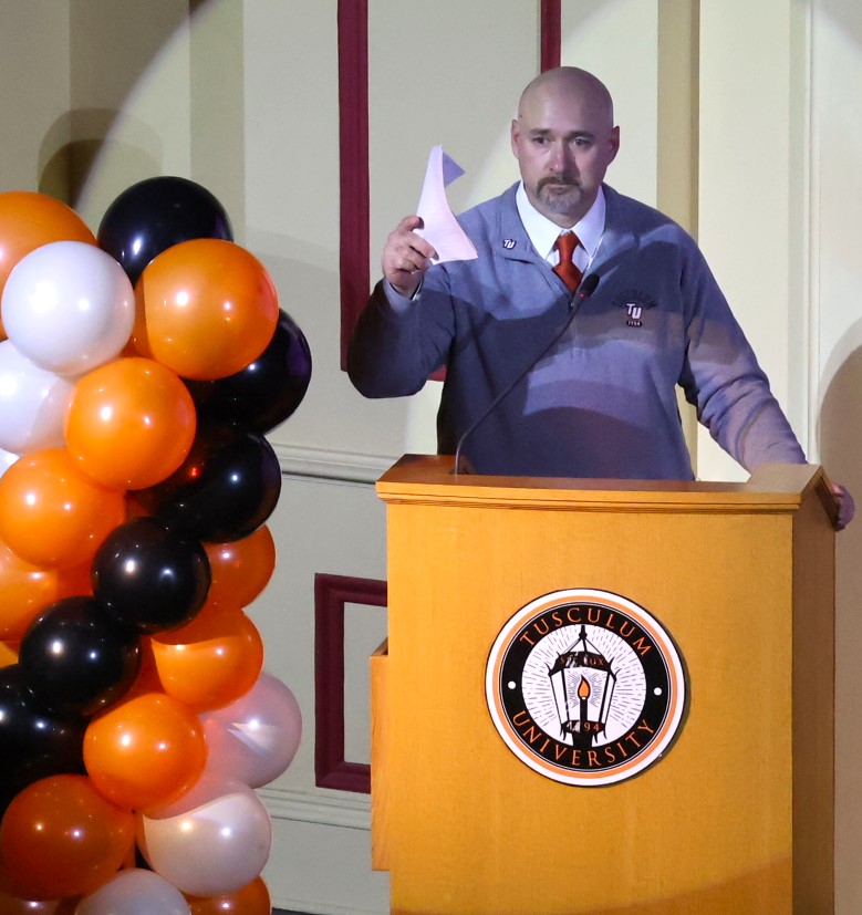 Mike Maggert, the emcee, speaks to the audience.
