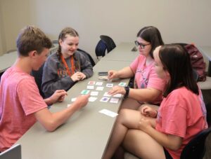 Students play a math card game at the Summer Academy in 2024.