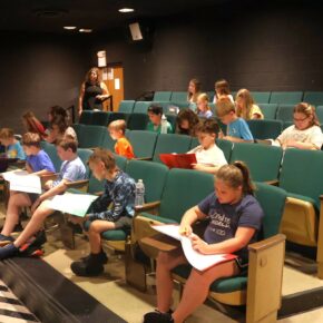 Participants in Theatre Camp read over a script in 2024.