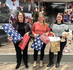 Left to right, Melissa Dixon, Angie Tyler and Chelsey Wade from TRIO show some of the gifts that program provided for the Angel Tree.
