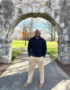 Chuck Sutton stands in front of the Tusculum Arch.