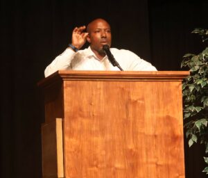 Chuck Sutton addresses new students and their families during Pioneer WOW.