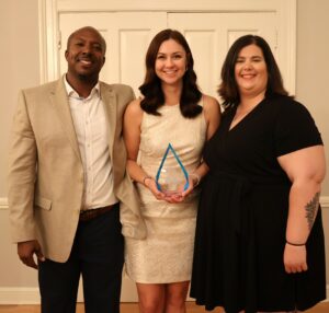 Claire Hensley, middle, celebrates her honor with Chuck Sutton, left, and Katie Odoms, both of whom work with her in the Office of Student Affairs.