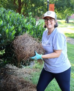 Rachael Barnett performs landscaping work outside a residence hall.