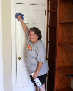 Rose Webb cleans a door in one of the houses that will be used for Tusculum’s new Discipleship Living-Learning Center.