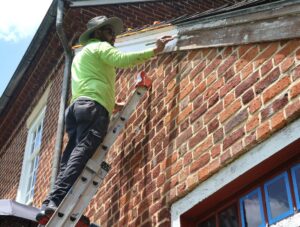 Eleazar Cruz Castillo tackles trim at the Doak House Museum.