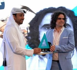 Doncho Donchev, right, holds an award he received during the exhibition in Qatar.