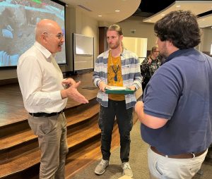 Dr. Yosef “Yossi” Garfinkel, left, speaks with Eirik Dahlgren, middle, and Hughston Burnheimer at the conclusion of his 2022 lecture. Dahlgren and Burnheimer were students at the time but have since graduated.