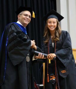 Dr. Scott Hummel, left, congratulates Paulina Loretz after she walked the stage at graduation.