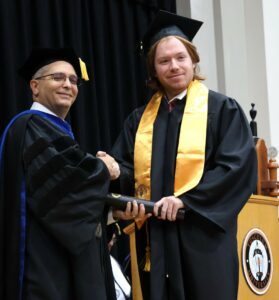 Dr. Scott Hummel, left, congratulates graduate Zach Mitchell.