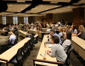 Students, faculty and staff participate in the Academic Symposium in the lecture hall Friday.