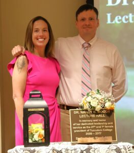 Mykel Johnson, left, and Adam Moody stand behind the plaque marking the name of the Dr. Nancy B. Moody Lecture Hall. Johnson and Moody, who are the children of Dr. Moody, are also standing by a lantern provided as part of the dedication.
