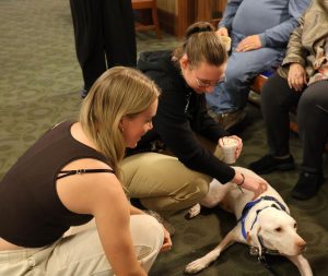 Students pet the therapy dog.