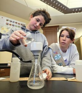 Girl Scouts filter a water sample in the Meen Center.