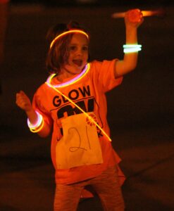 A girl has fun as a prior year’s Glow Run.