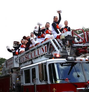 Cheerleaders and Zeke, the university’s mascot, ride in the parade.