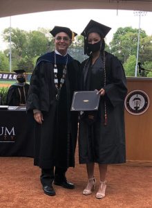 Dr. Hummel posing with a student holding their award