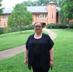 Angelia Jarstfer stands in front of the Thomas J. Garland Library at Tusculum.