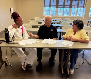 Dr. Thomas Nuzzi, middle, shares information about the Master of Arts in Leadership.