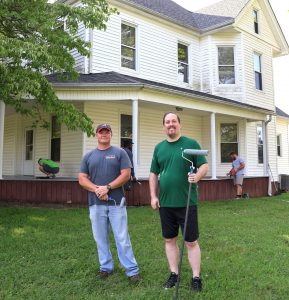 Dr. David Cook, right, and the Rev. E.J. Swatsell, stand outside the house in July, when painting was taking place.